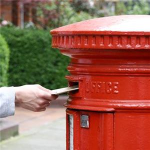 View of someone posting a package into a letter box